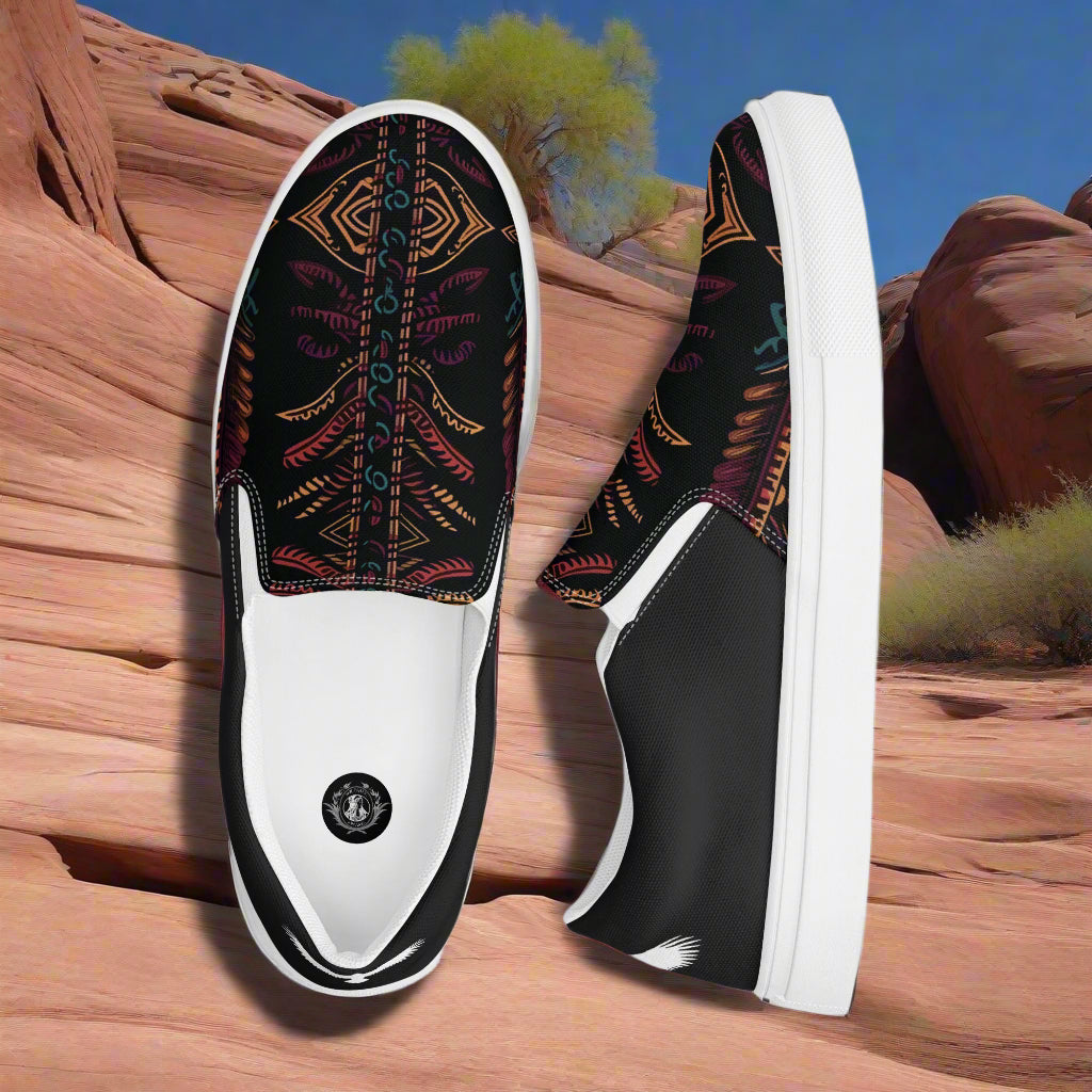 Iktomi Halftone Slip-on Canvas Shoes featuring a vibrant tribal design on a black background