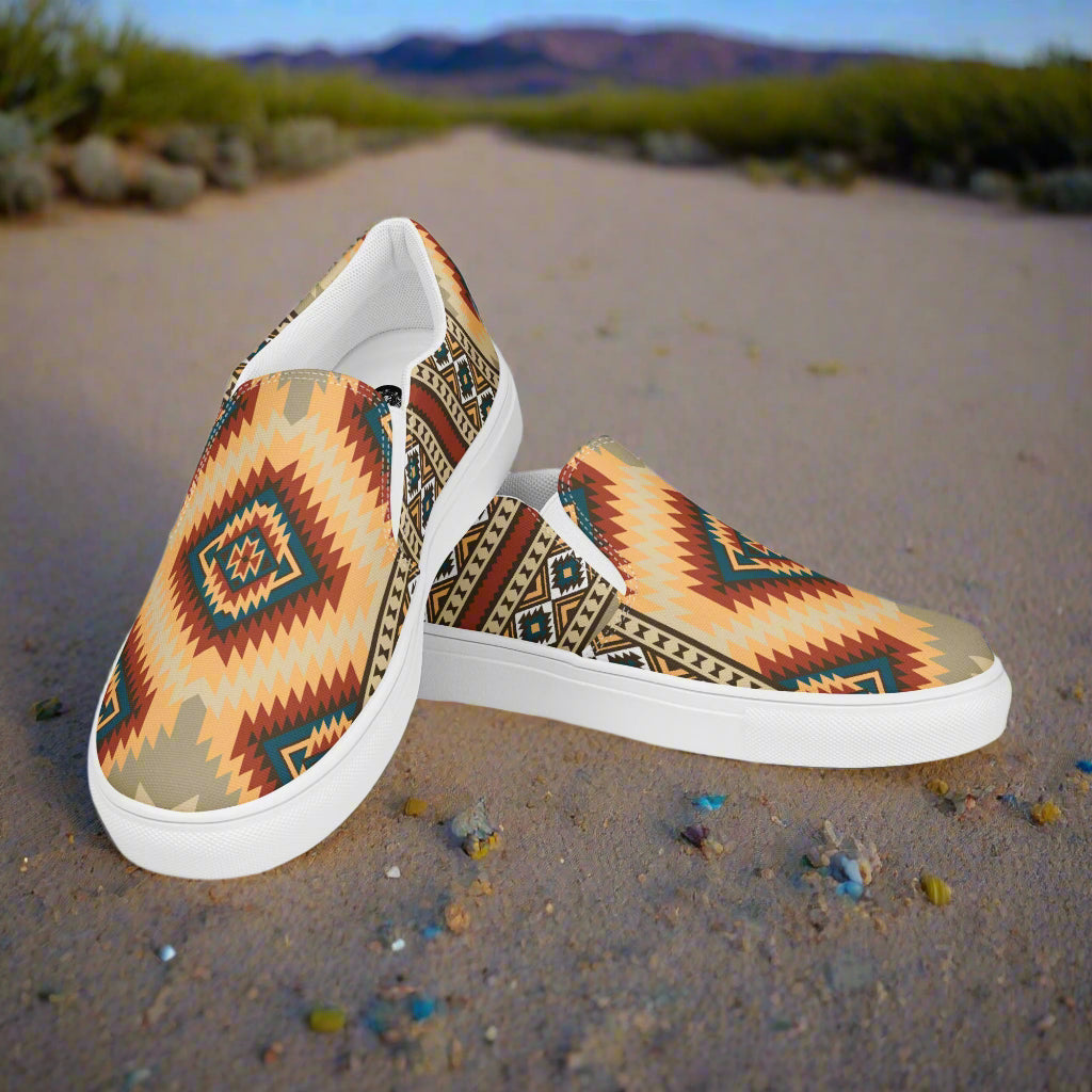 Kayenta Southwest Print Slip-on Canvas Shoes featuring colorful tribal patterns on a desert pathway