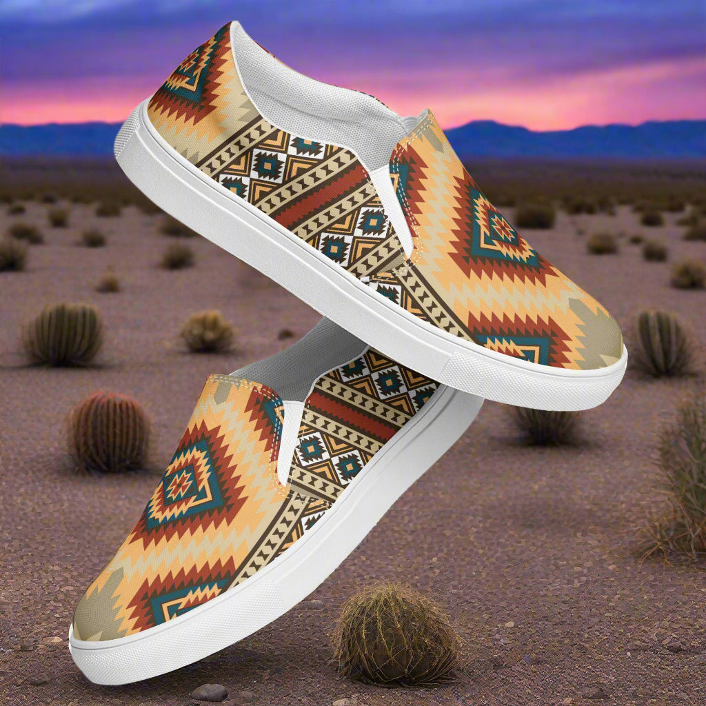 Kayenta Southwest Print Slip-on Canvas Shoes showcasing vibrant tribal patterns in sandy outdoor setting