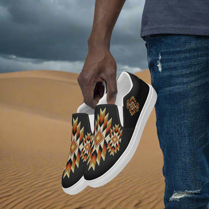 Mens Southwest pattern slip-on canvas shoes featuring vibrant tribal designs on a sandy background