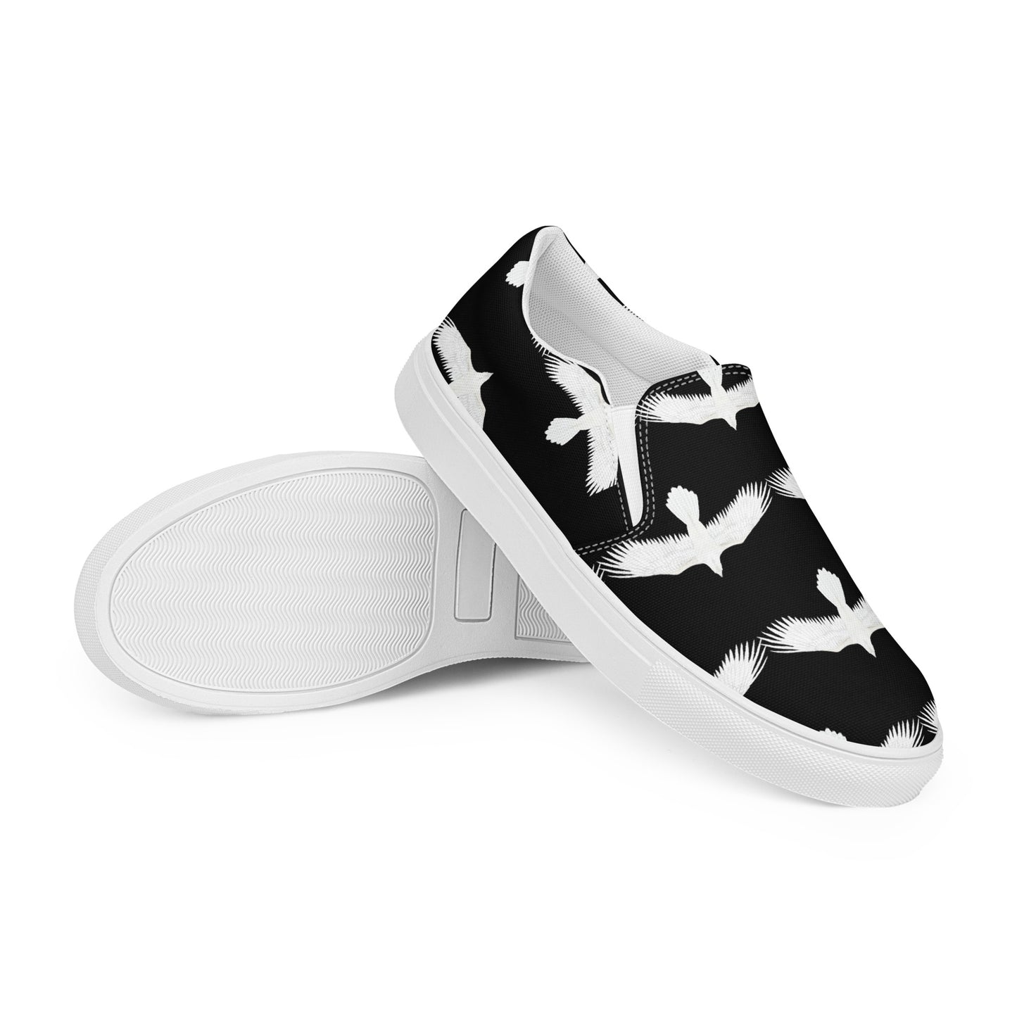 Mens white raven print slip on shoes by WildSage Market with black background and white bird design