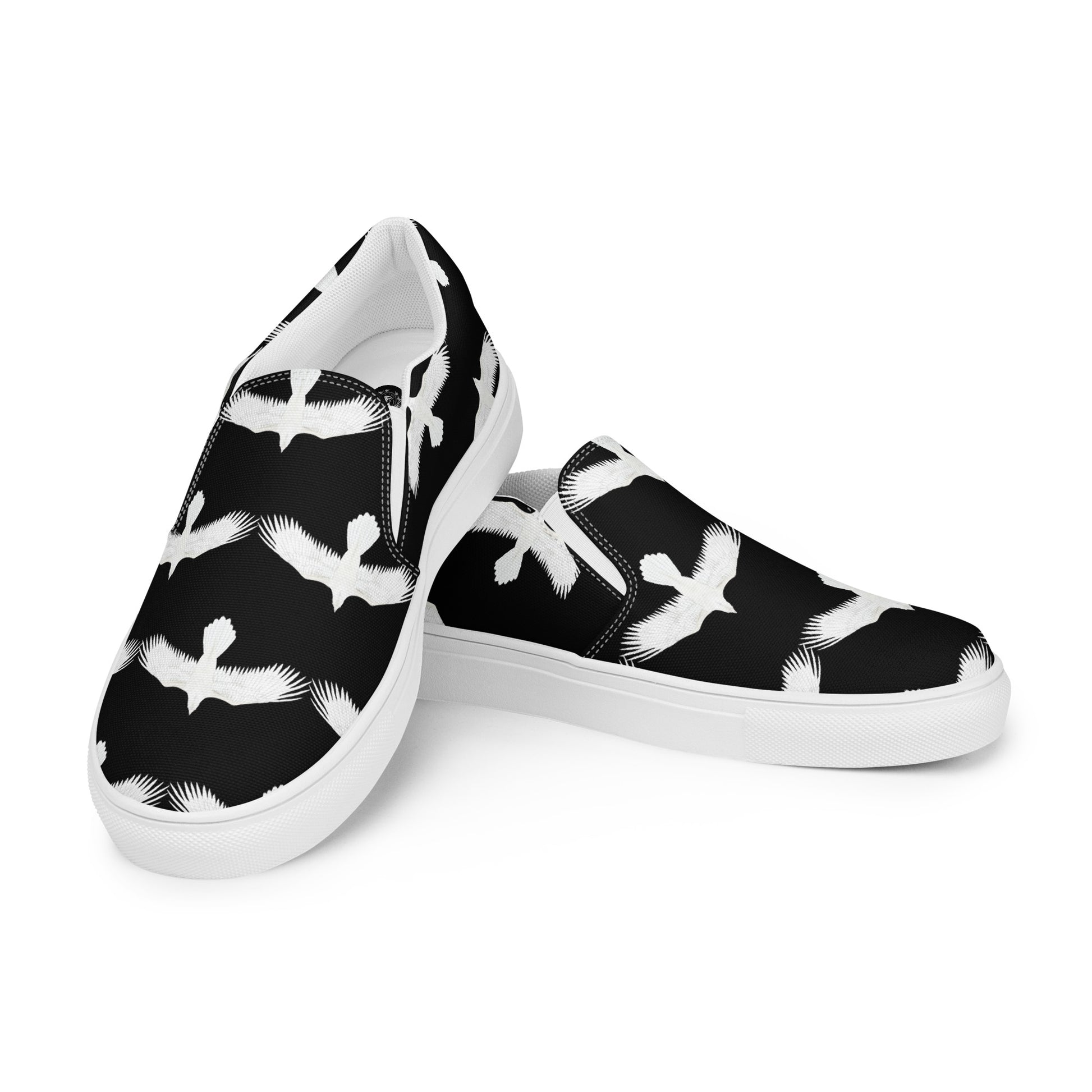 Mens white raven print slip on shoes with black background and white rubber sole by WildSage Market