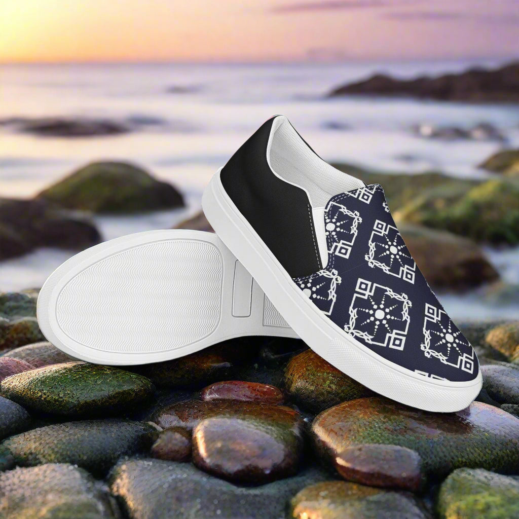 Moroccan Sun Halftone Slip-on Canvas Shoes featuring a stylish design on a rocky beach background