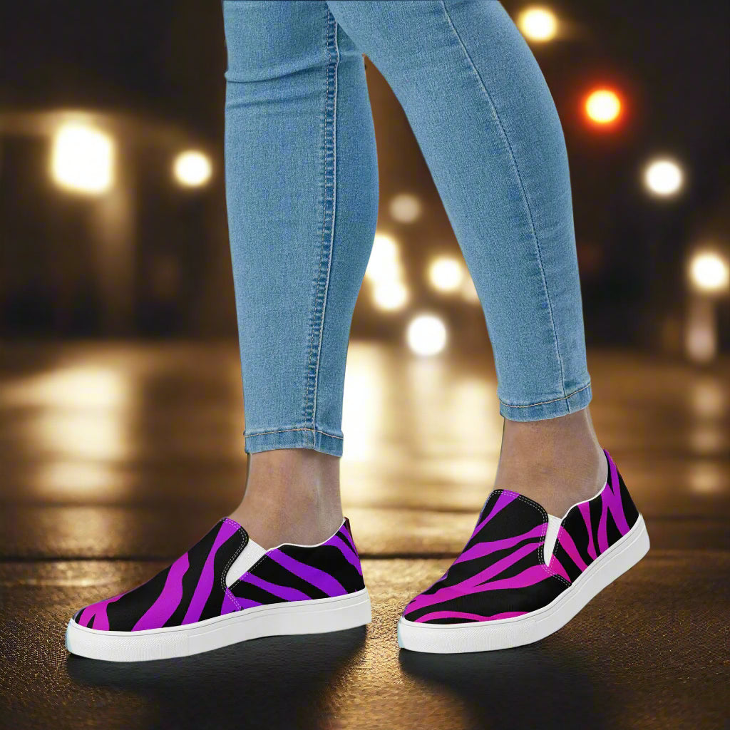 WildSage Market Purple Zebra Canvas Shoes slip on shoes in bright purple zebra print on city street