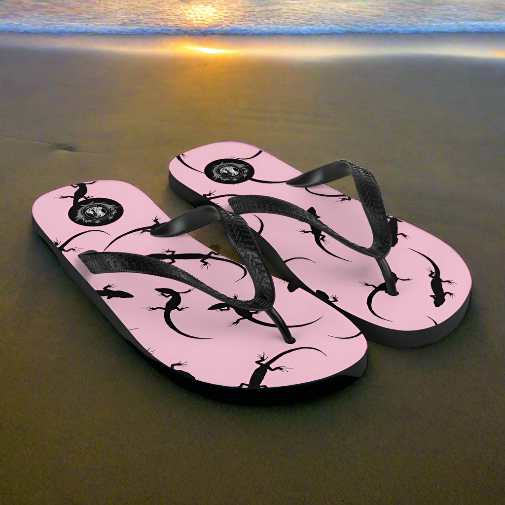 Stylish pink lizard flip-flops with black lizard designs perfect for beach outings and casual wear