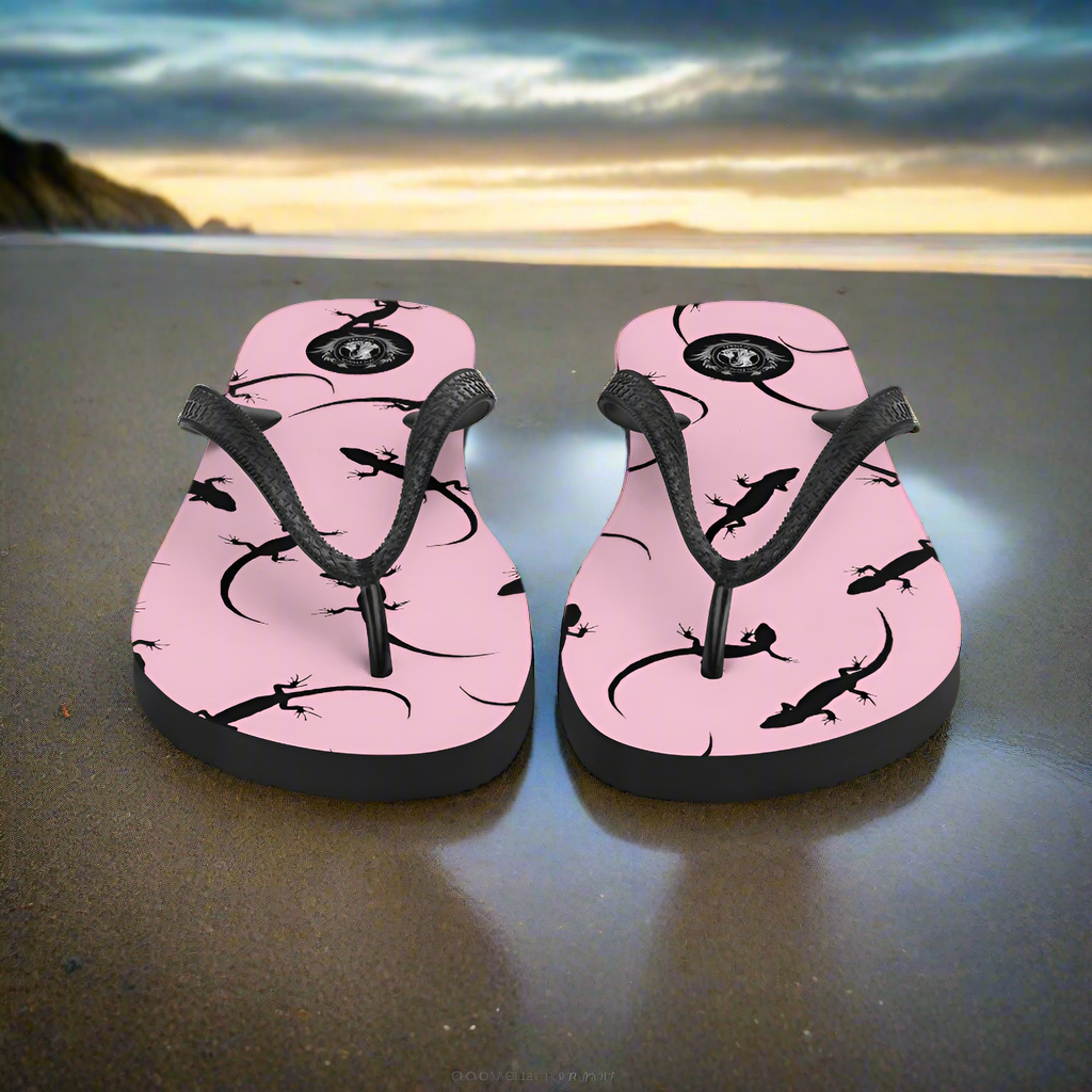 WildSage Market pink lizard flip-flops featuring a stylish lizard design on a beach background