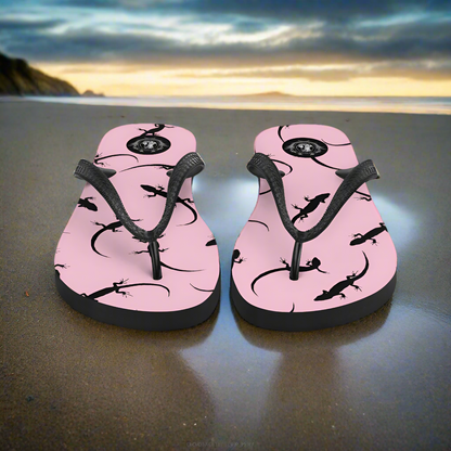 WildSage Market pink lizard flip-flops featuring a stylish lizard design on a beach background