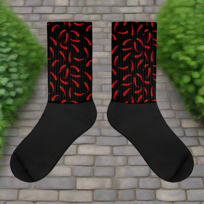 Red and black hot chili socks featuring a vibrant chili pepper pattern for a fun style