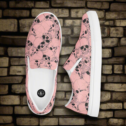 WildSage Market slip on shoes with pink skull pattern and white soles on brick background