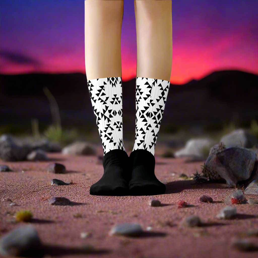 Sonora White Unisex Black Bottom Socks featuring a stylish geometric pattern on a scenic desert backdrop