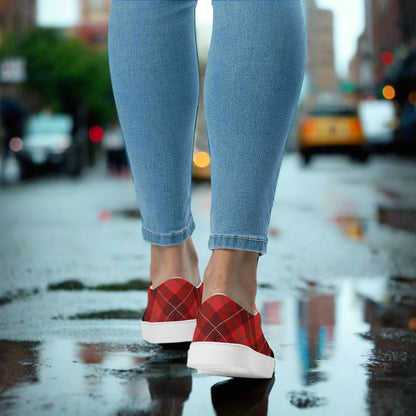 Plaid Red Slip-On Canvas Shoes by WildSage Market worn with ankle jeans on wet city street with puddle reflection