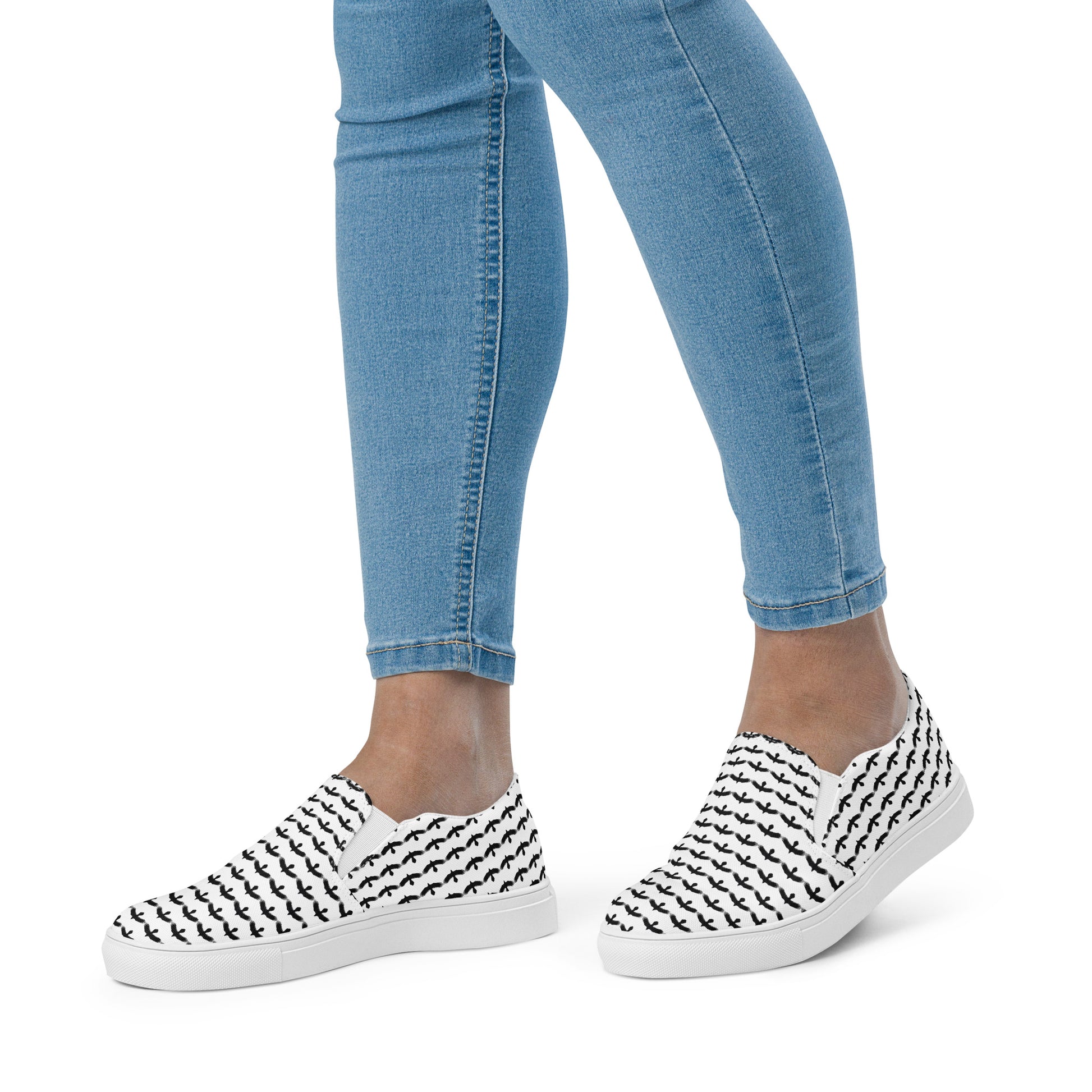 WildSage Market black raven pattern slip on shoes worn with blue jeans for casual style