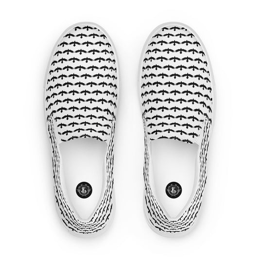 WildSage Market black raven pattern slip on shoes with white background and repeating raven design
