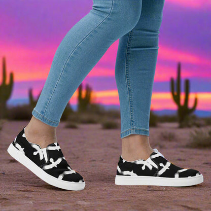 WildSage Market white Ravens slip on canvas shoes with a black and white pattern worn with jeans