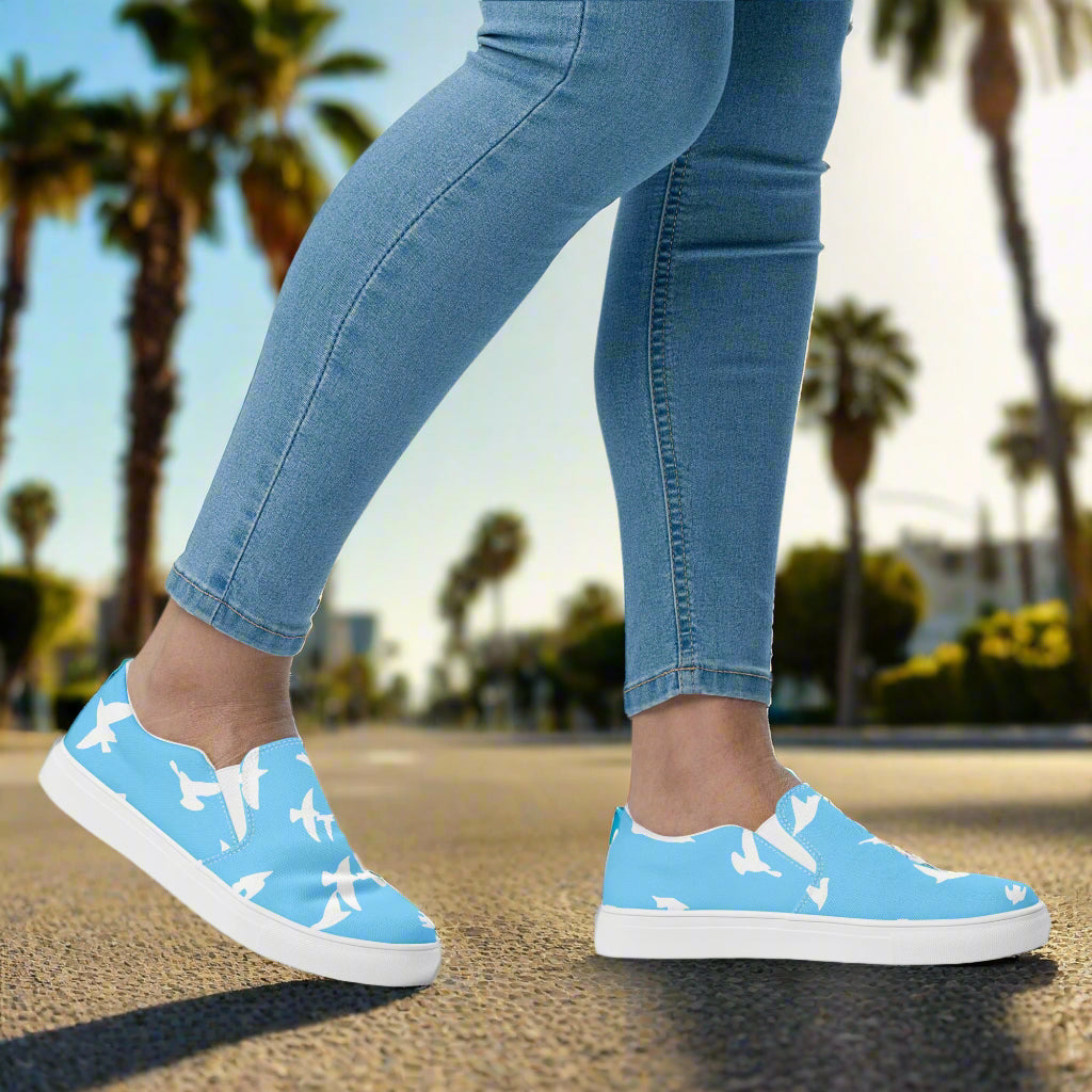 Stylish Whitebirds Blue Slip-on Canvas Shoes worn with jeans on a sunny street