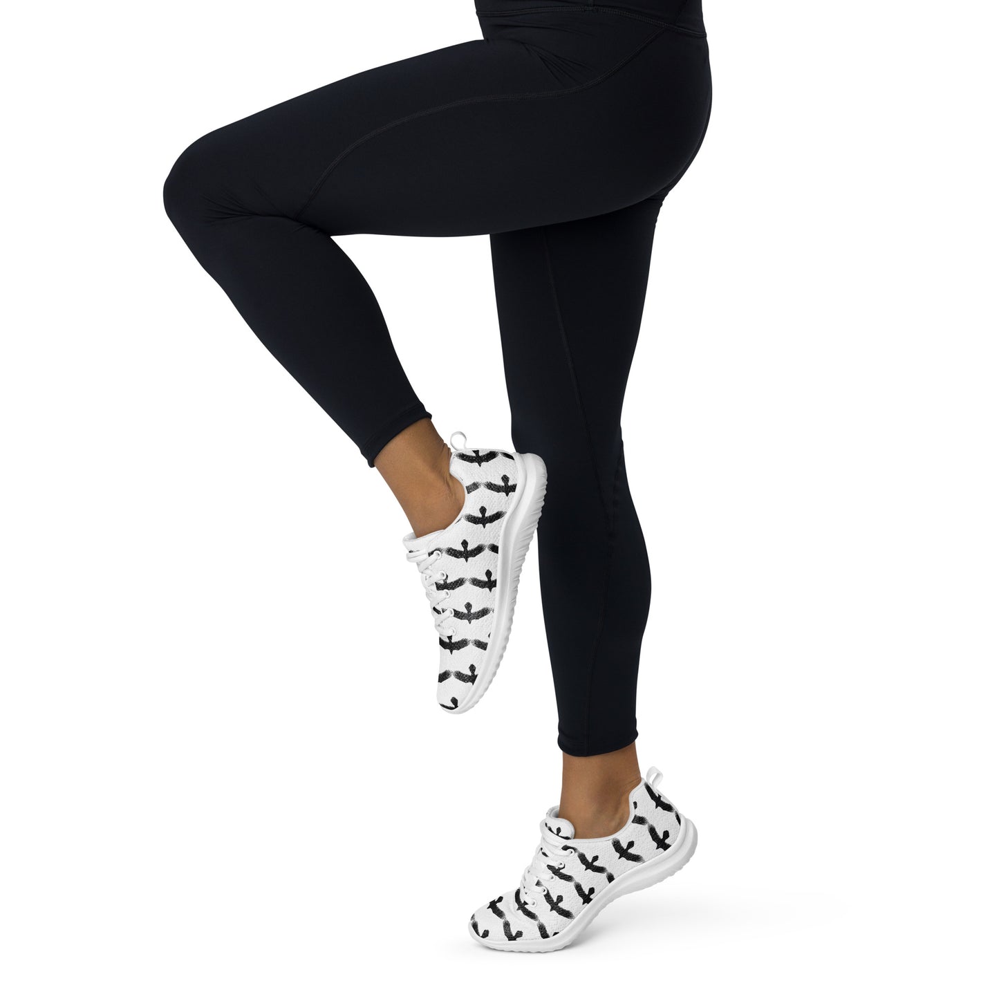 Womens black raven pattern athletic shoes worn with black leggings in active pose