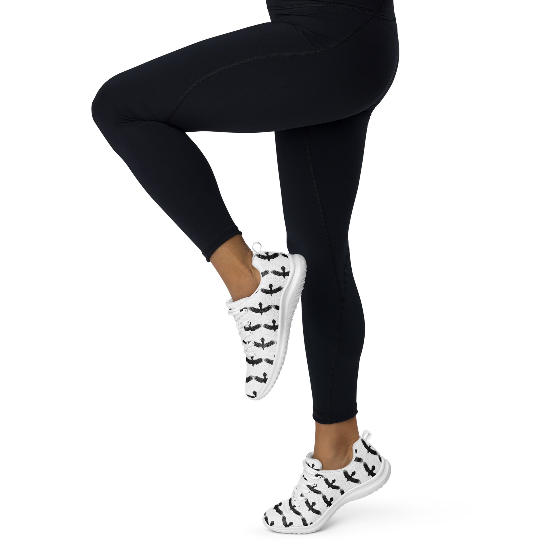 Womens black raven pattern athletic shoes worn with black leggings in active pose