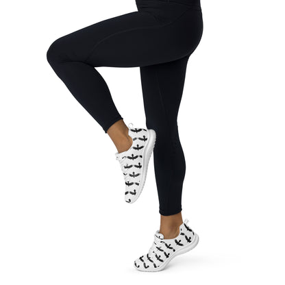 Womens black raven pattern athletic shoes worn with black leggings in active pose