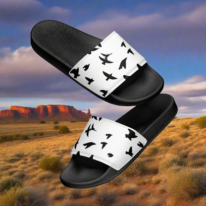 Womens blackbird print slides by WildSage Market with black soles and white straps featuring black bird silhouettes