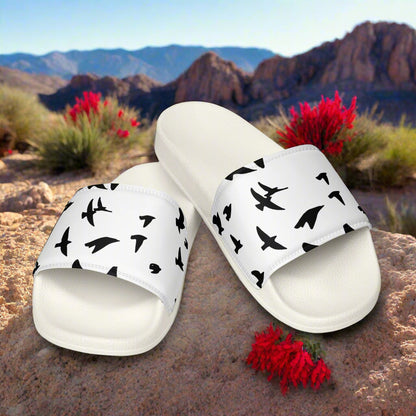 WildSage Market womens blackbird print slides with black bird silhouettes on white straps outdoors