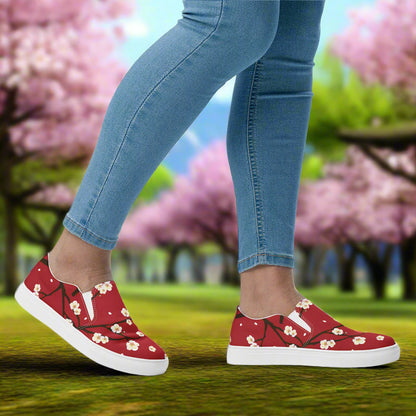 Womens Red Blossom floral print slip on shoes by WildSage Market worn with blue jeans outdoors