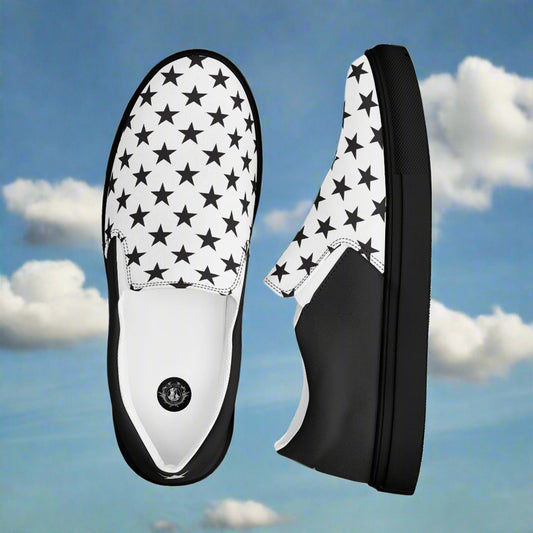 white slip on canvas shoes with a black star pattern and black soles