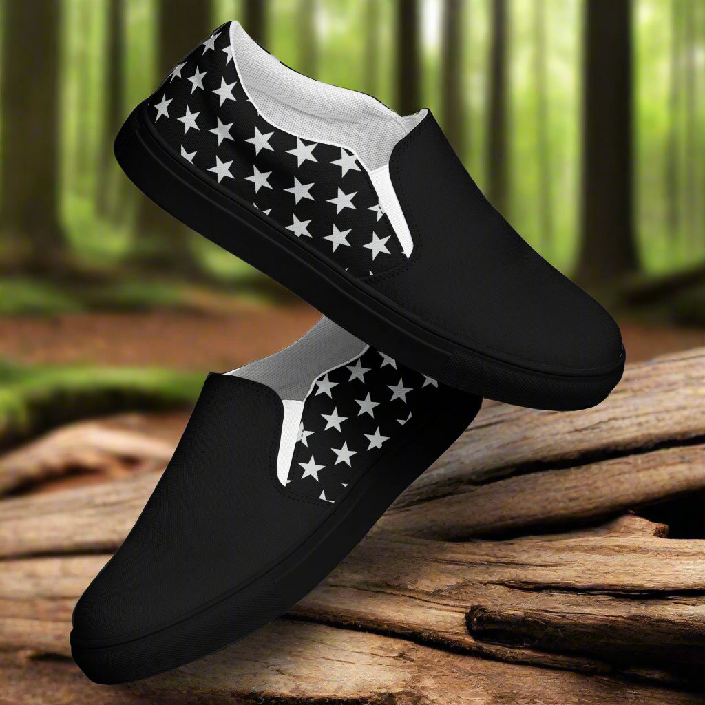 black canvas slip-on shoes with a white star pattern