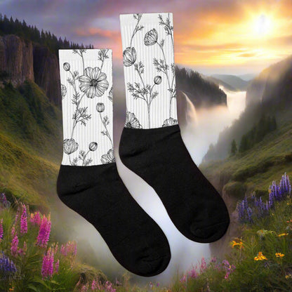Womens White Floral Print Socks with Black Poppy Pattern against a scenic nature background