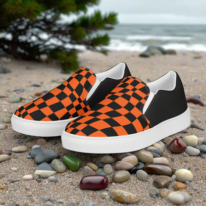 Wonderland Orange Chex Halftone Slip-On Canvas Shoes featuring a bold orange and black design on a beach setting