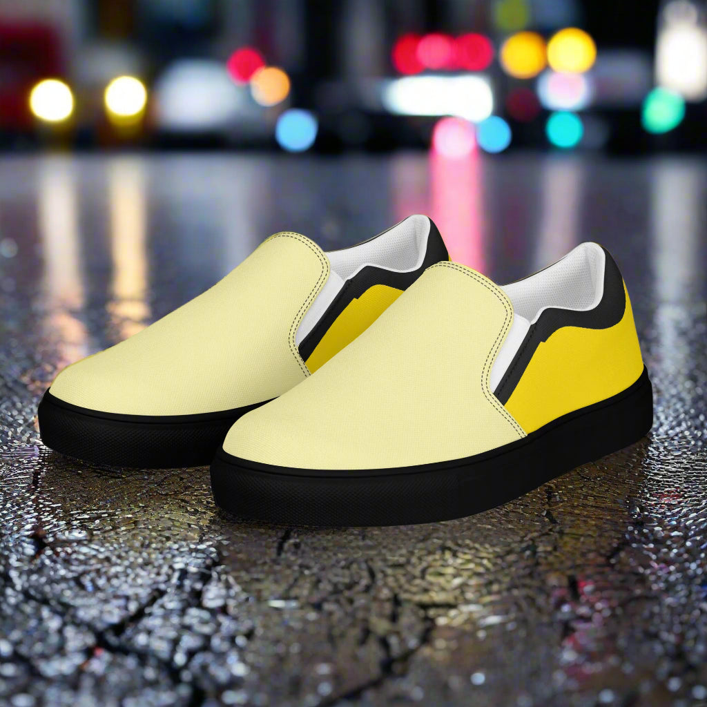 Yellow two tone slip on canvas shoes by WildSage Market with black soles on wet pavement